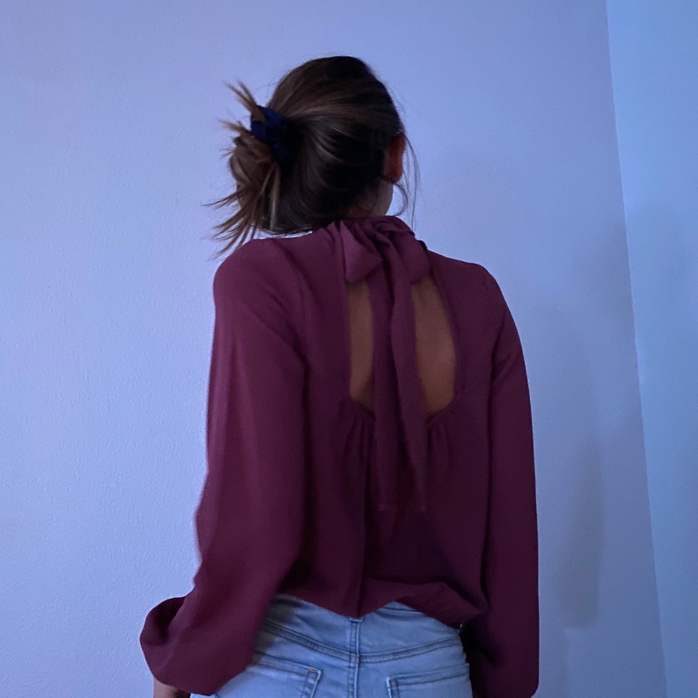 Burgundy blouse with open back.